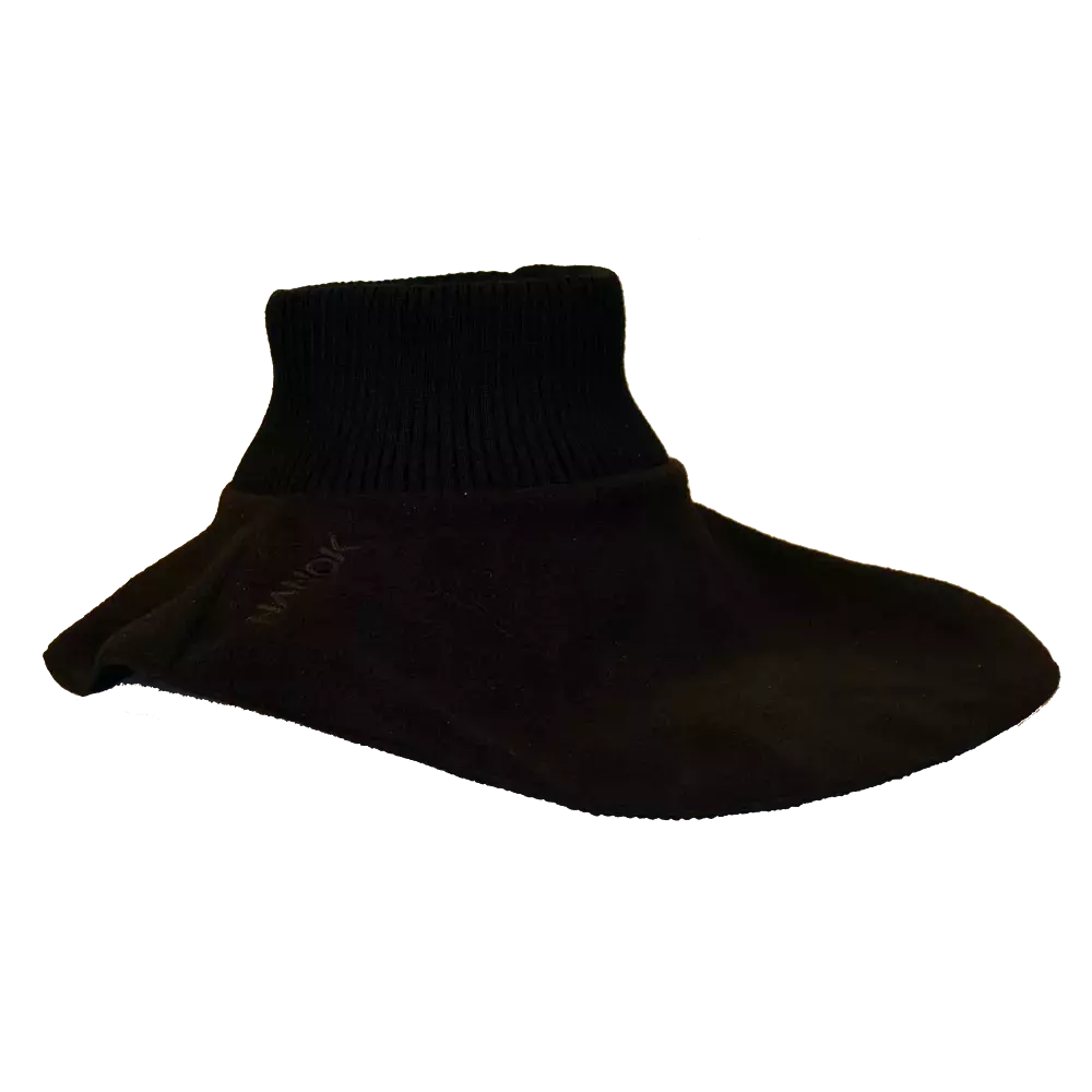 Dette billede viser en sort indendørs sok eller fodpose med et ribstrikket ankelskaft og en glat, tætsiddende krop. Materialet virker blødt og lidt strækbart, designet til at omslutte foden tæt og give varme og komfort. Sokken har et enkelt, ensfarvet udseende uden synlige mønstre og passer til afslappet hjemmebrug, hvor man ønsker let beskyttelse og varme til fødderne.