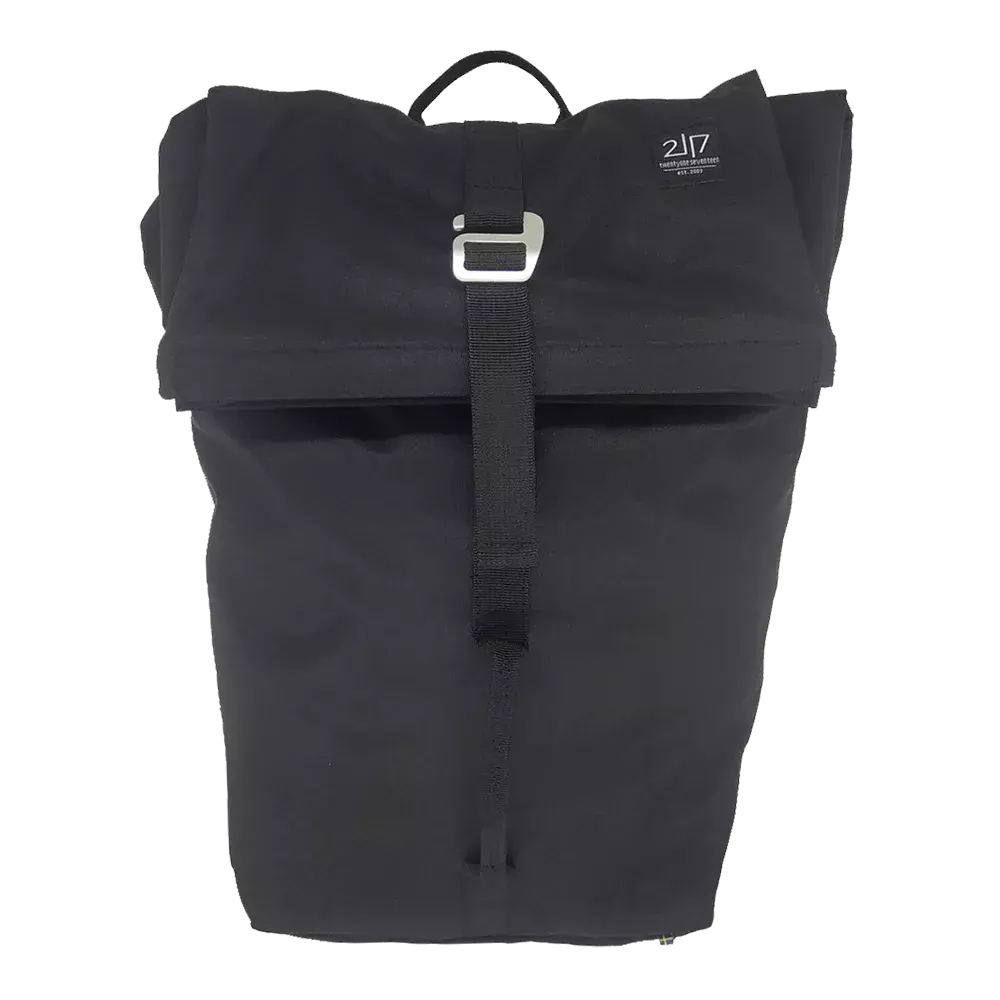 Rygsækken er enkel og funktionel i mat sort materiale med en rullet toplukning og et solidt spænde i midten. Designet er minimalistisk med rene linjer, et lille logo øverst til højre og et praktisk bærehåndtag. Den lukkes med en bred strop, hvilket gør den velegnet til hverdag, pendling eller cykelture. Indvendigt er der god plads til bøger, en bærbar computer og daglige fornødenheder.