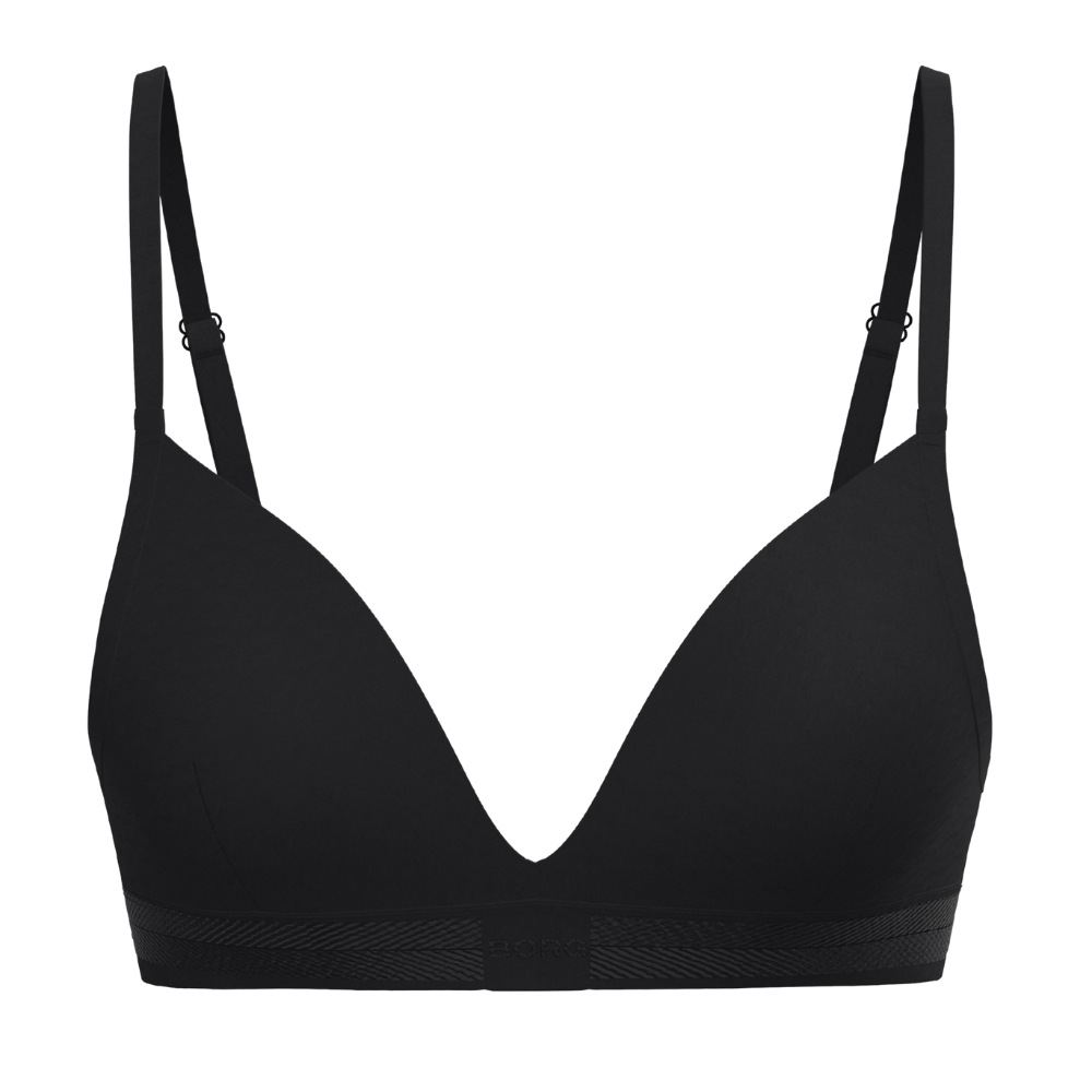 En enkel, sort bh med rene linjer og diskret, minimalistisk design. Den har bløde, formede skåle, dyb udskæring og tynde, justerbare stropper for individuel tilpasning. Underbåndet er elastisk med en subtil tekstur, der sikrer støtte uden bøjler. Materialet virker glat og behageligt mod huden, hvilket gør bh'en ideel til hverdagsbrug under tætsiddende tøj eller til afslappet komfort.