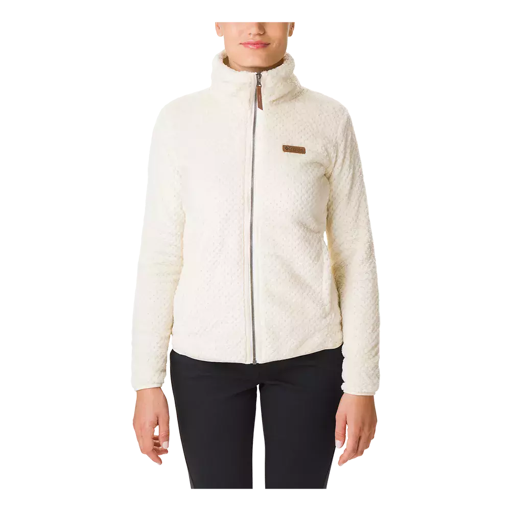 En elegant, cremefarvet fleecejakke med høj krave og fuld lynlås ses over sorte bukser. Jakken har en blød, let struktureret overflade, tætsiddende pasform og et lille brunligt logo på brystet. Den giver et enkelt, moderne look og passer godt til hverdagens kølige dage eller som lag-på-lag til udendørsaktiviteter. Stilren og funktionel med fokus på komfort.