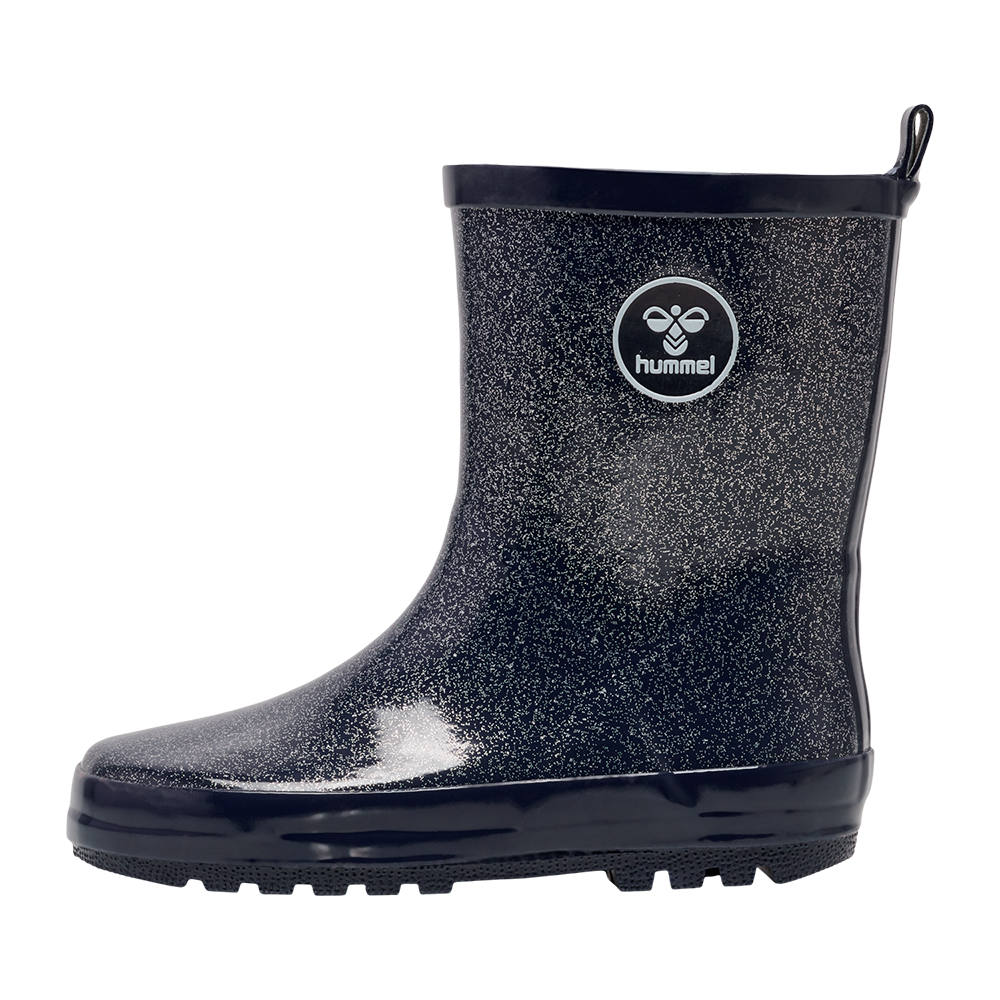 Et enkelt, mørkeblåt gummistøvle med diskret glimmerpræg og blank overflade. Støvlen har en kraftig, skridsikker sål, opret skaftekant og en lille trækrem bagtil for nem påtagning. På ydersiden ses en rund hummel-logo, som giver et sporty udtryk. Praktisk til regnvejr og mudder, kombinerer den funktionalitet med et stilrent, legende design og komfort.