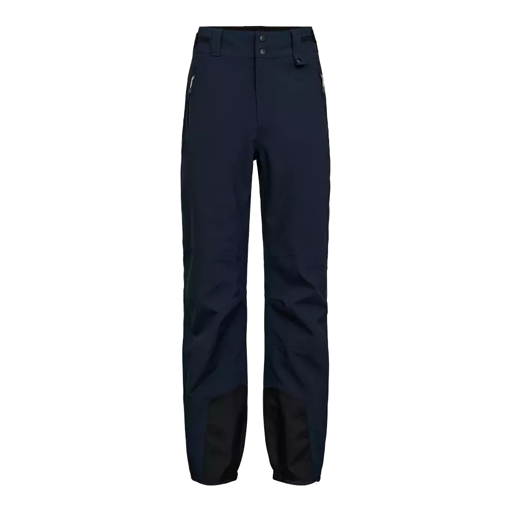 Mørkeblå, tekniske bukser designet til outdoor-aktiviteter. Høj talje med dobbelte knapper og bæltestropper, to lynlåslommer i siderne og forstærkede indersømme ved foden. Slank, lige pasform med let formede knæ for bevægelsesfrihed. Materialet ser vandafvisende og slidstærkt ud, velegnet til vandreture, skiløb eller hverdag med fokus på funktionalitet og holdbarhed. Enkelt, moderne udtryk.