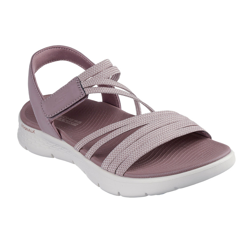 Lys rosa-lilla sandal med bred, hvid sål og blødt, støddæmpende indlæg. Flere elastiske remme krydser forfoden og sikrer fleksibilitet, mens en justerbar velcrorem ved anklen giver ekstra støtte. Materialet fremstår let og behageligt med en tekstureret overflade, velegnet til hverdag og gåture. Skoens design kombinerer komfort og sporty elegance i et enkelt, moderne look.