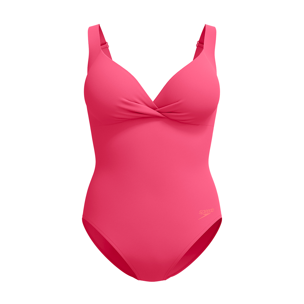 En intens pink badedragt i enkelt, moderne design. Den har brede justerbare stropper, en dyb V-udskæring med snoet frontdetalje og formstøbte skåle, som giver støtte og en glat silhuet. Materialet fremstår glat og elastisk med en diskret Speedo-logo ved hoften. Badedragten har klassisk benudskæring og virker både funktionel til svømning og flatterende til afslappede stranddage.