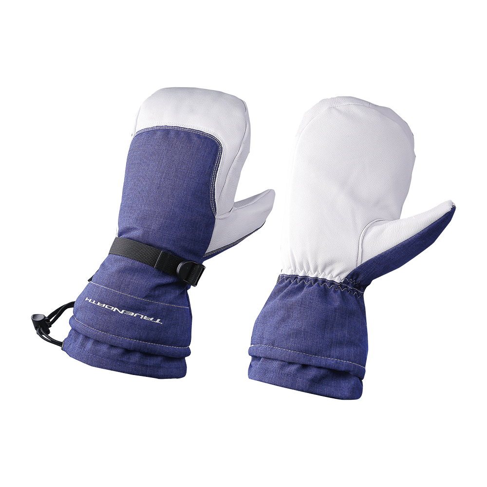 På billedet ses et par robuste vintervotter i mørkeblå og hvid. Håndfladerne er dækket af slidstærkt hvidt materiale (læder eller syntetisk), mens bagsiden og manchetterne er i blåt tekstil. Votterne har en justerbar rem ved håndleddet, elastisk indgang samt forstærkede syninger og blødt, varmt foer, som sikrer god pasform og isolering. Designet virker praktisk til skiløb, snerydning eller kolde udendørsaktiviteter.