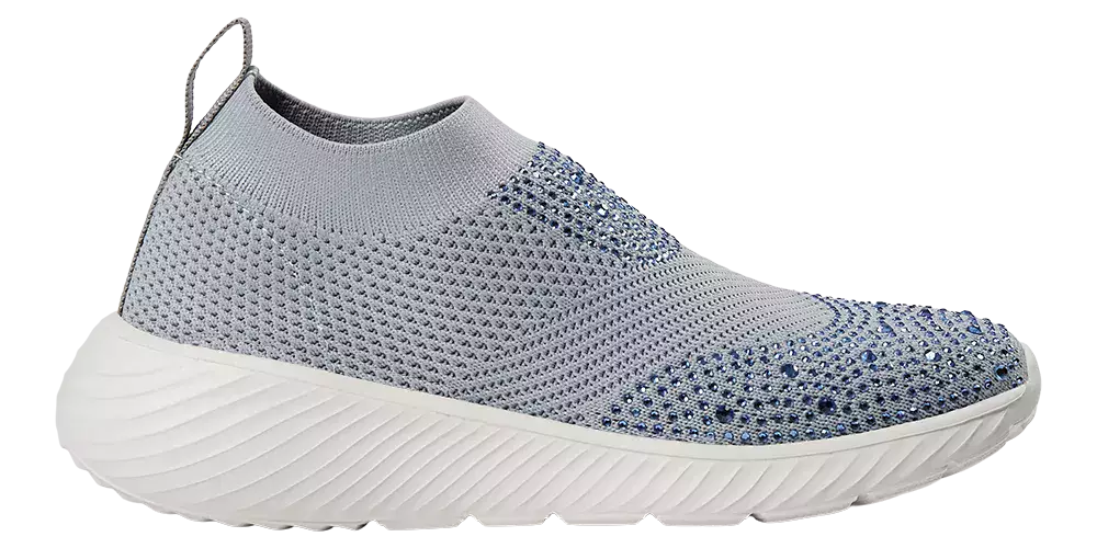 Skoen er en moderne slip-on sneaker i lysegrå strik med en soklignende åbning og en lille hælstrop. Overfladen har et åndbart mesh-mønster og små blå pyntesten, der giver diskret glans mod forfoden. Den hvide, bølgede sål er tyk og let, designet til stødabsorbering og komfort. Stilren og sporty kombinerer modellen komfort til hverdag med et feminint, dekorativt touch.
