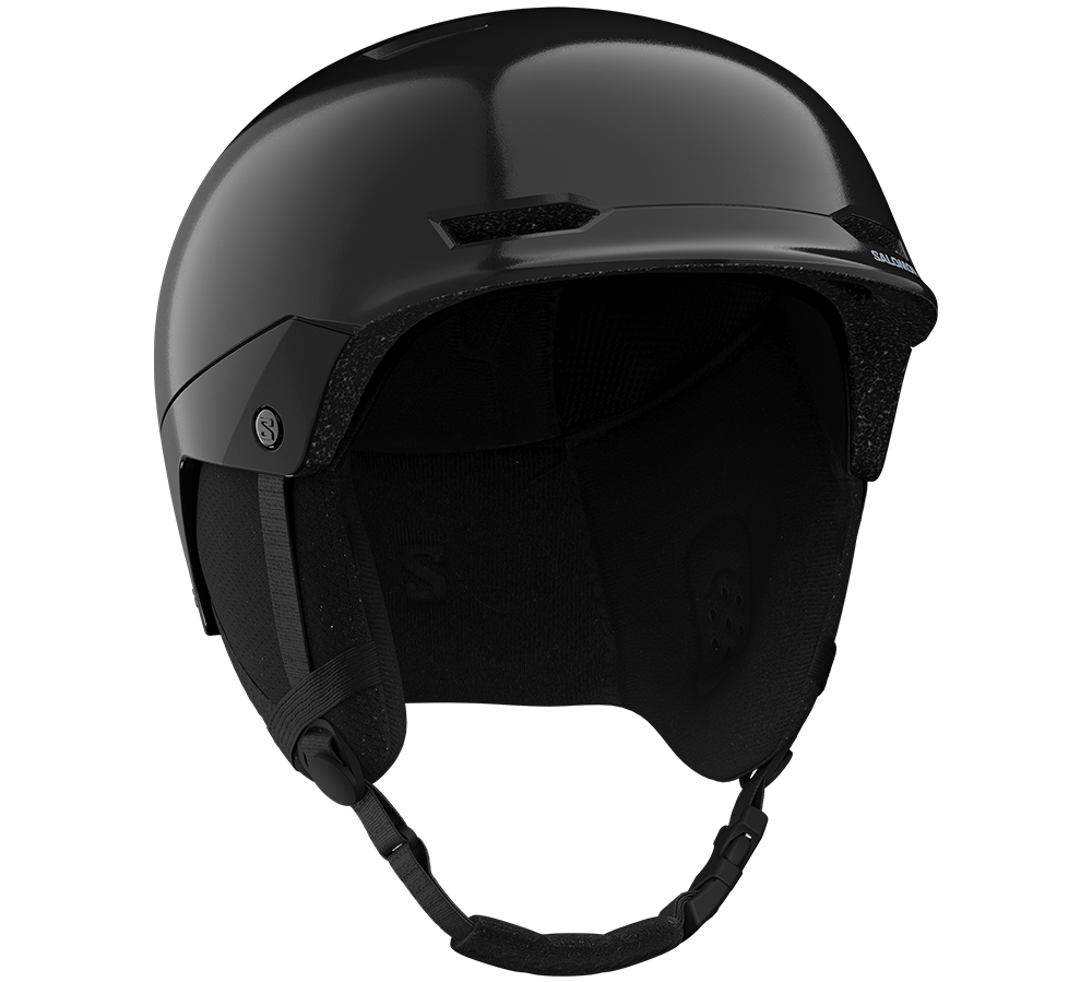 Skihjelm i sort med Salomon-logo, ventilationsåbninger, polstret inderside og hagerem.