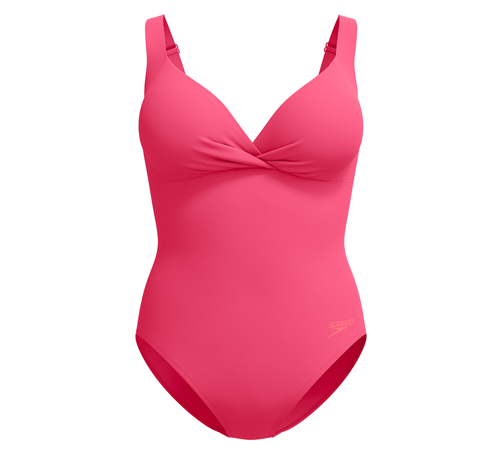 En intens pink badedragt i enkelt, moderne design. Den har brede justerbare stropper, en dyb V-udskæring med snoet frontdetalje og formstøbte skåle, som giver støtte og en glat silhuet. Materialet fremstår glat og elastisk med en diskret Speedo-logo ved hoften. Badedragten har klassisk benudskæring og virker både funktionel til svømning og flatterende til afslappede stranddage.